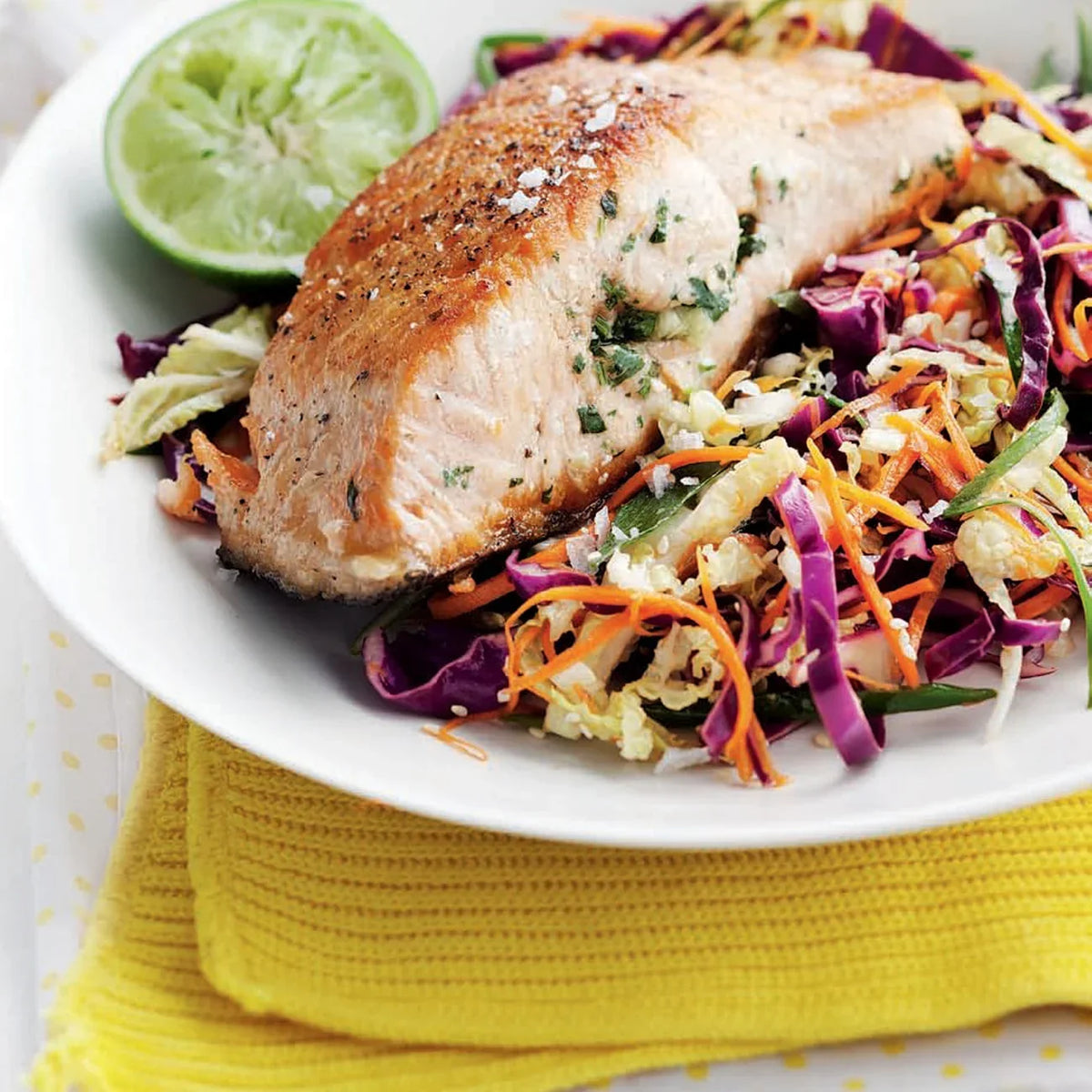 Tri-color Slaw plated with grill salmon and lime slice 