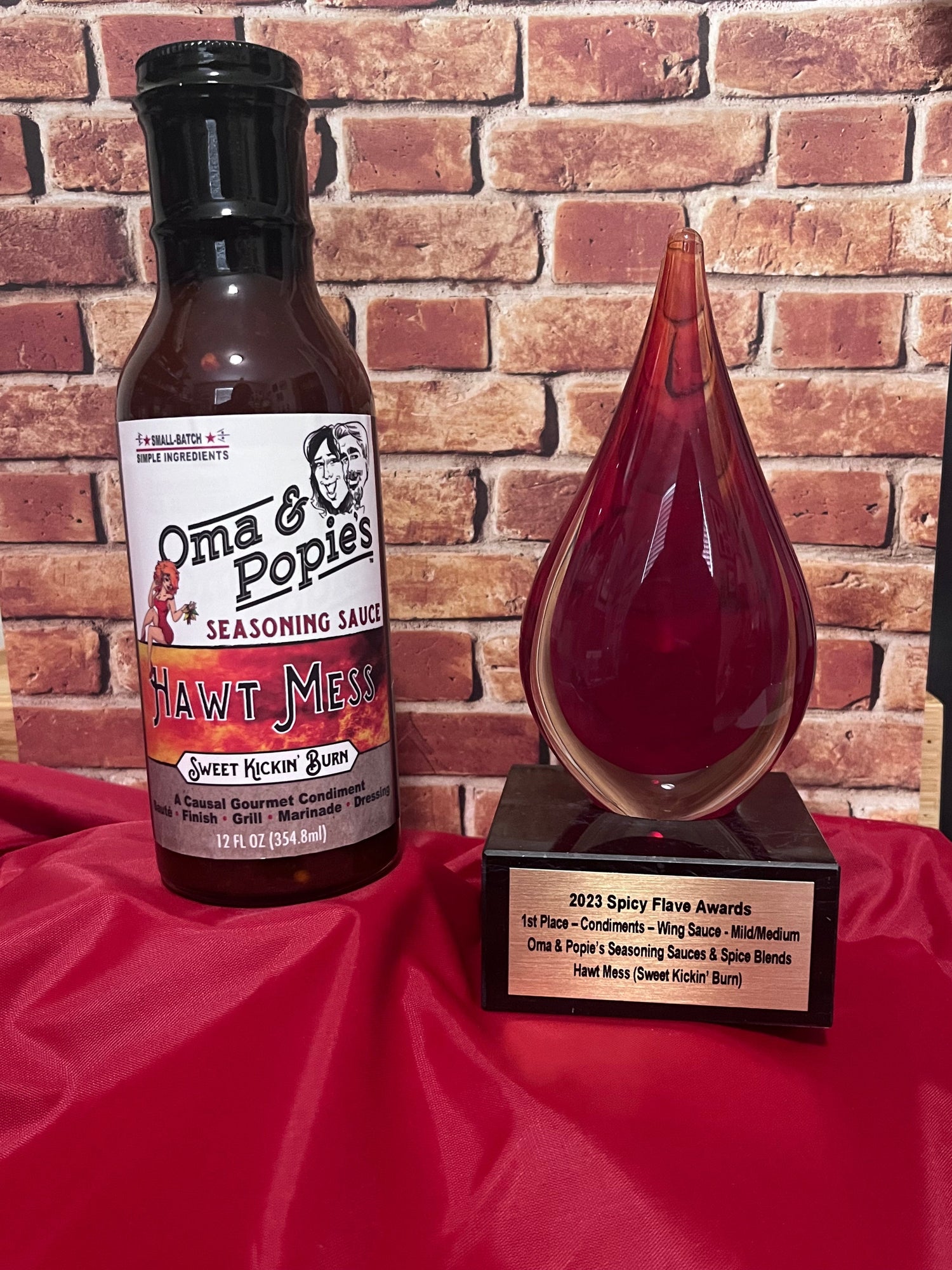Bottle of Hawt Mess Sauce and teardrop award 